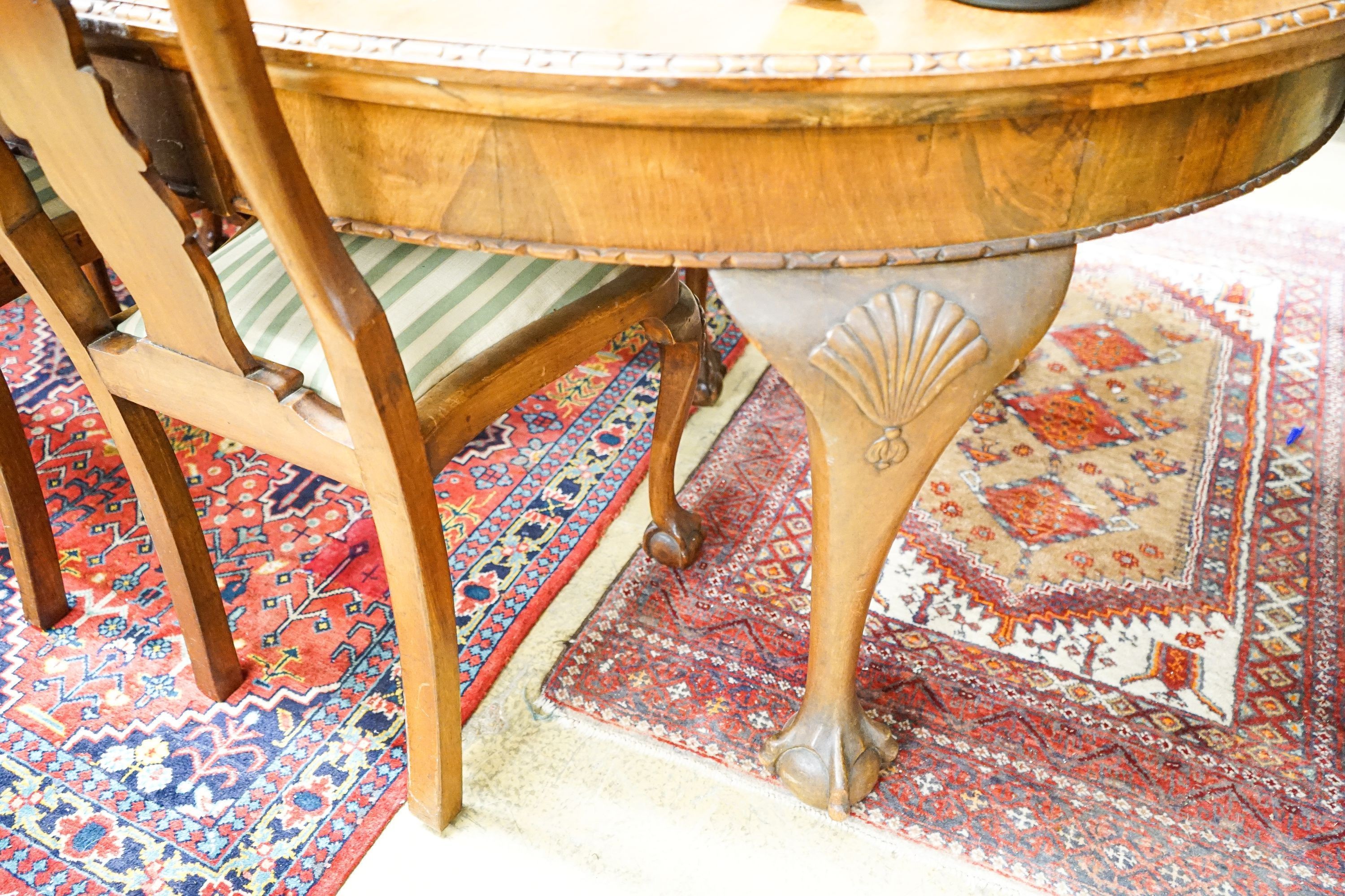 A Queen Anne style figured walnut dining suite comprising extending dining table, 200cm extended (one spare leaf), width 104cm, height 76cm, six chairs (two with arms) and a concave fronted sideboard